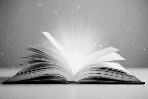 Open book with light representing brand story and alignment